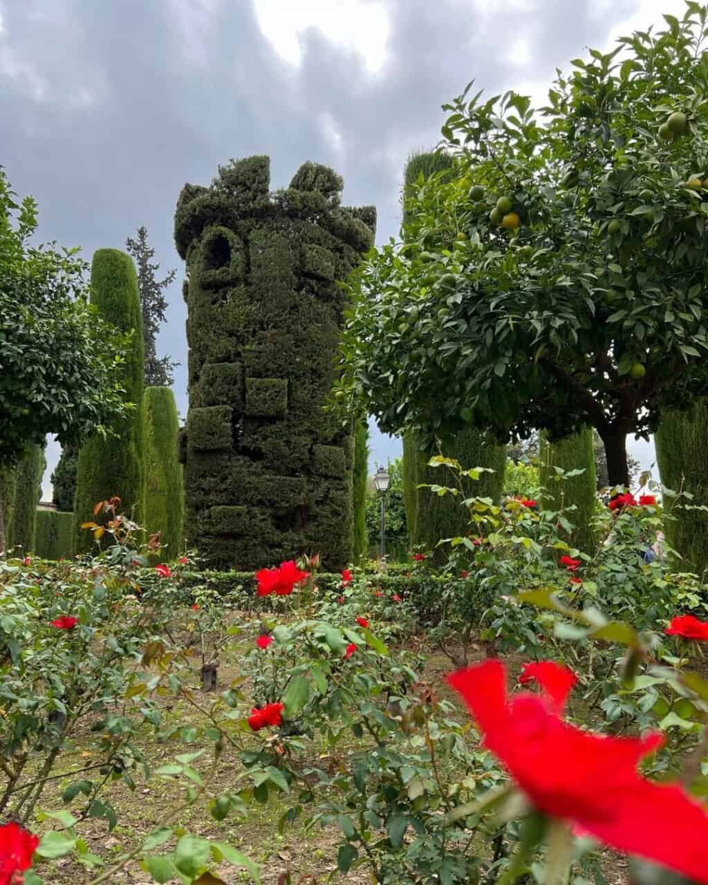 a clover topiary tower in the gardens beside the fortress in cordoba