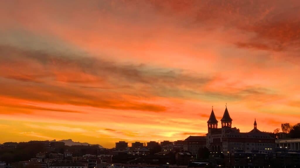 stunning orange sunrise over the hills of san sebastian spain