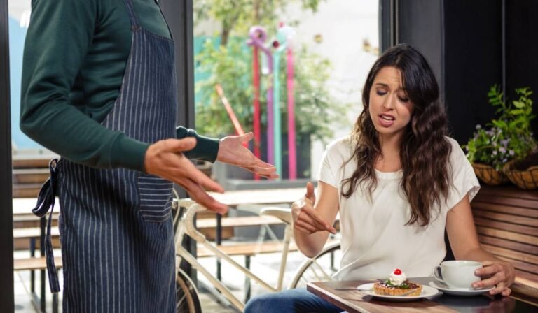 angry cafe patron complaing to waiter