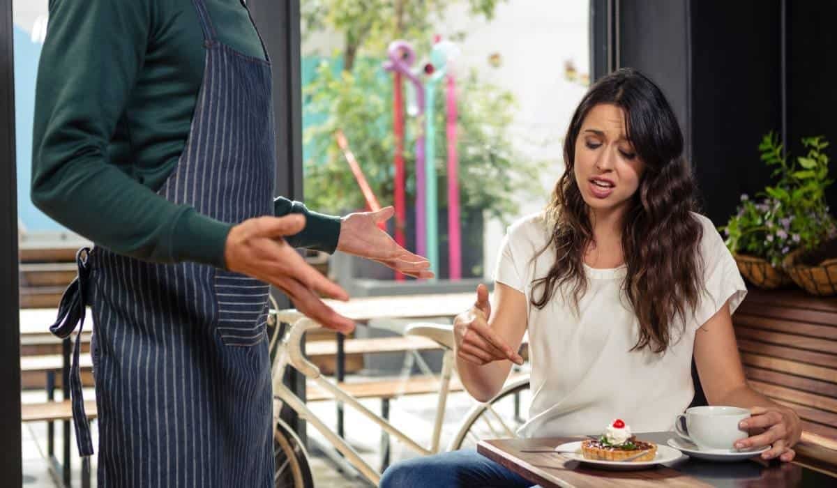 angry cafe patron complaing to waiter